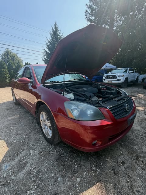 2006 Nissan Altima in for a valve cover, spark plugs and coil packs